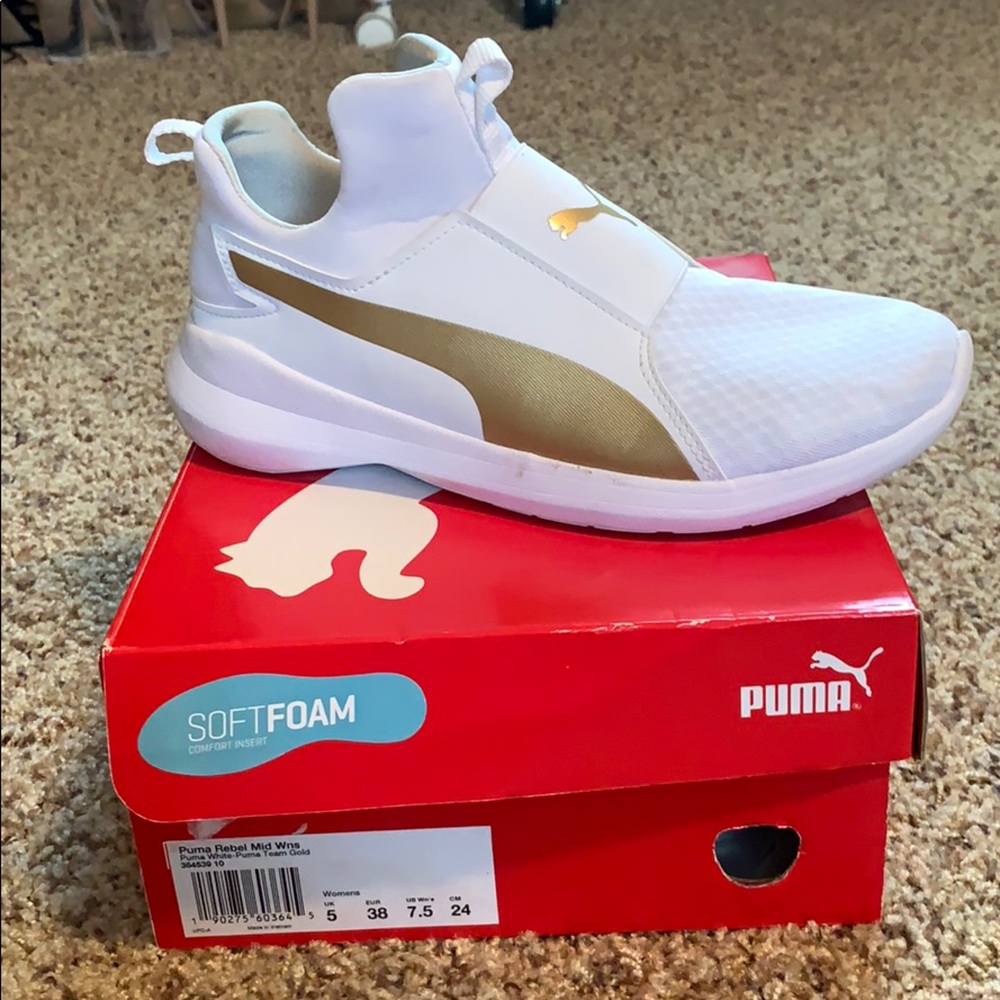 White and gold soft foam Puma sneakers.